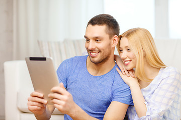 Image showing smiling happy couple with tablet pc at home