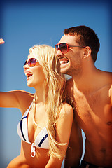 Image showing happy couple in sunglasses on the beach