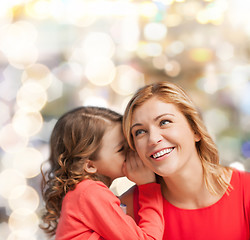 Image showing smiling mother and daughter whispering gossip