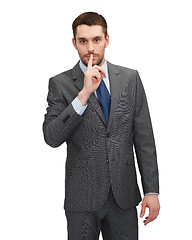 Image showing handsome businessman with finger on his lips