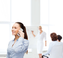 Image showing young smiling businesswoman with smartphone