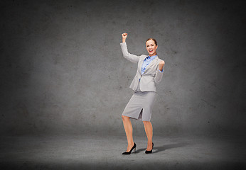 Image showing happy businesswoman with hands up