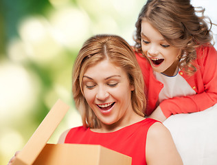 Image showing smiling mother and daughter opening gift box