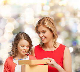 Image showing smiling mother and daughter with gift box