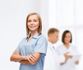 Image showing smiling female doctor or nurse