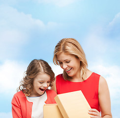 Image showing smiling mother and daughter with gift box