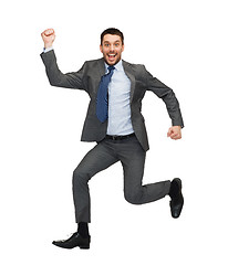 Image showing smiling businessman jumping