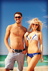 Image showing happy couple in sunglasses on the beach