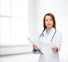 Image showing calm female doctor with clipboard