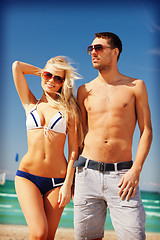 Image showing happy couple in sunglasses on the beach