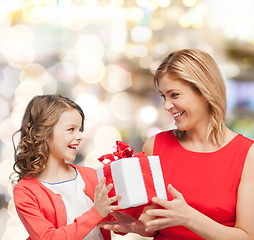 Image showing smiling mother and daughter with gift box