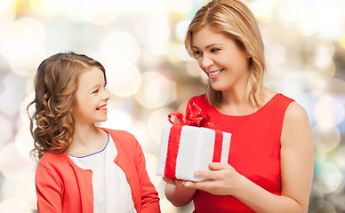 Image showing smiling mother and daughter with gift box