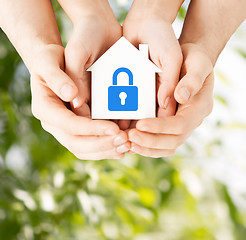 Image showing hands holding paper house with lock