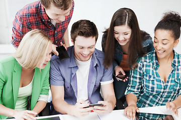 Image showing students looking into smartphone at school