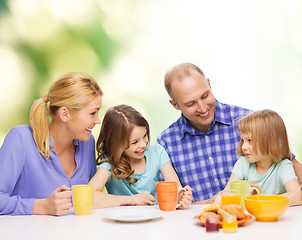 Image showing happy family with two kids with having breakfast