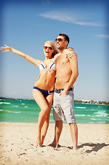 Image showing happy couple in sunglasses on the beach