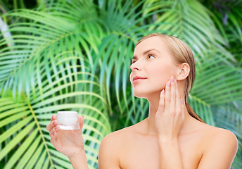 Image showing woman applying cream on her skin