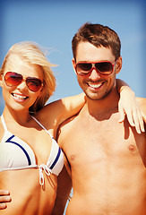 Image showing happy couple in sunglasses on the beach