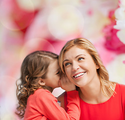 Image showing smiling mother and daughter whispering gossip