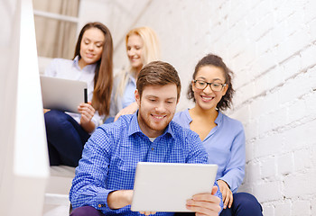 Image showing team with tablet pc computer sitting on staircase