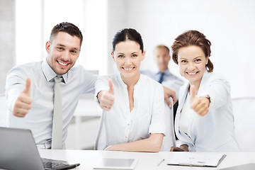 Image showing business team showing thumbs up in office