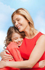 Image showing smiling mother and daughter hugging