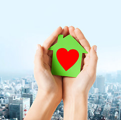 Image showing hands holding green paper house