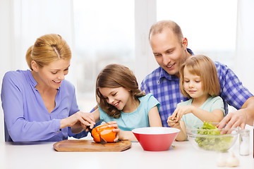 Image showing happy family with two kids making dinner at home