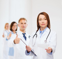 Image showing calm female doctor with clipboard