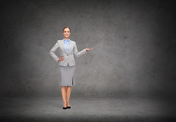 Image showing businesswoman showing something on her hand