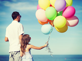 Image showing father and daughter with colorful balloons