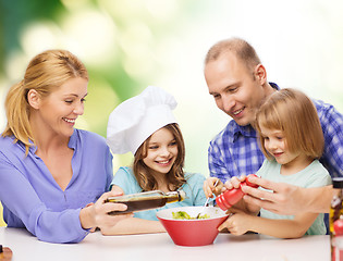 Image showing happy family with two kids eating at home