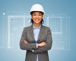 Image showing businesswoman in white helmet with crossed arms