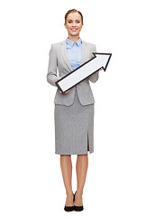 Image showing smiling businesswoman with direction arrow sign