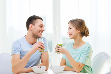 Image showing smiling couple having breakfast at home