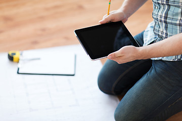 Image showing male with tablet pc, blueprint and measuring tape