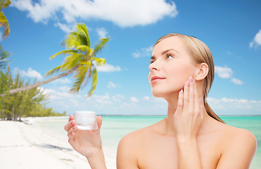 Image showing woman applying cream on her skin