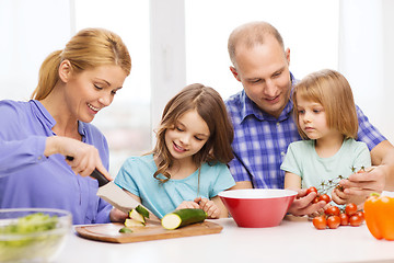 Image showing happy family with two kids making dinner at home