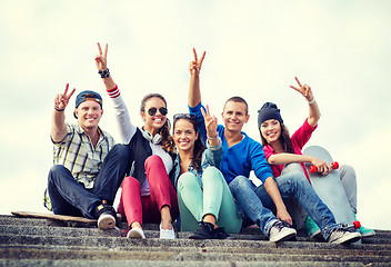 Image showing group of teenagers showing finger five