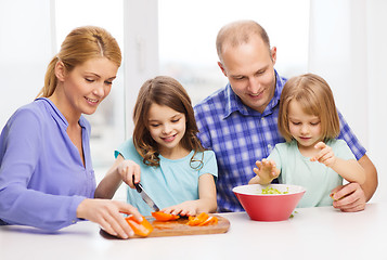 Image showing happy family with two kids making dinner at home