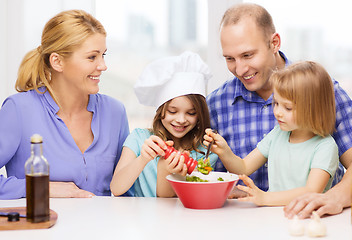 Image showing happy family with two kids making dinner at home