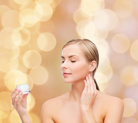 Image showing woman applying cream on her skin