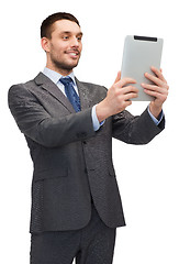 Image showing smiling buisnessman with tablet pc computer