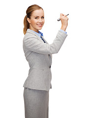 Image showing businesswoman writing something in air with marker