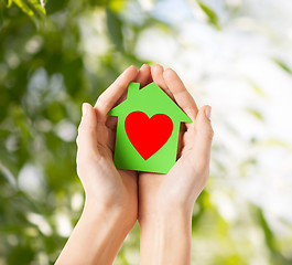 Image showing hands holding green paper house