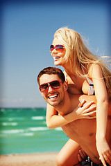 Image showing happy couple in sunglasses on the beach