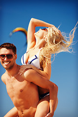 Image showing happy couple in sunglasses on the beach