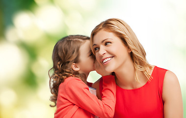 Image showing smiling mother and daughter whispering gossip