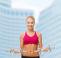 Image showing woman with heavy steel dumbbells