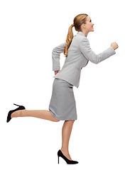 Image showing smiling businesswoman running